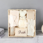 Spa bath gift set with brush, loofah, gloves, towel labeled 'Bath' in woven basket